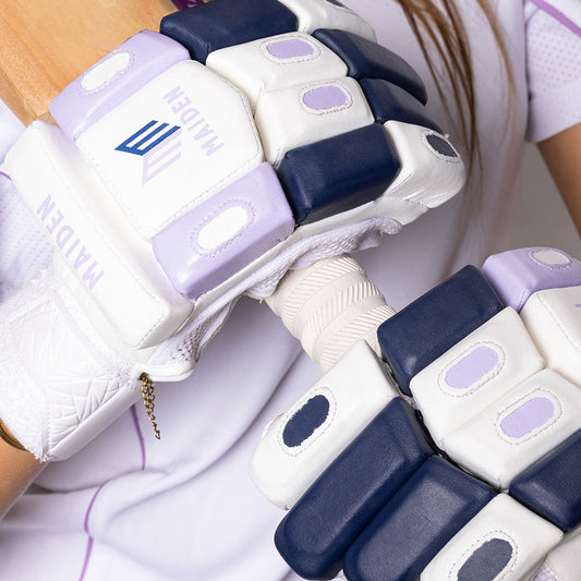 Close-up of a person wearing futuristic white and blue gloves with visible branding.