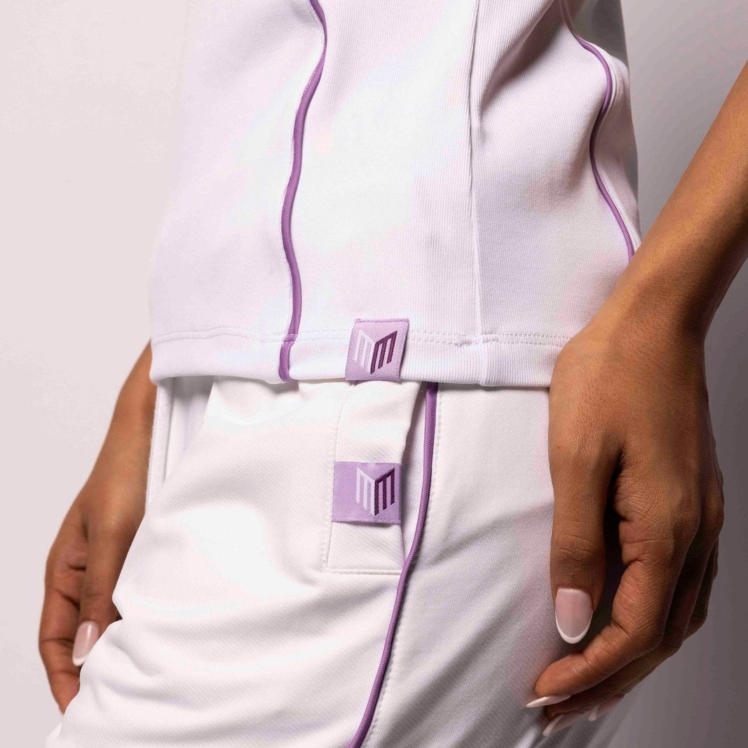 White outfit with purple accents on a plain background