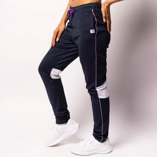 Person wearing black jogger pants with white accents on a plain background