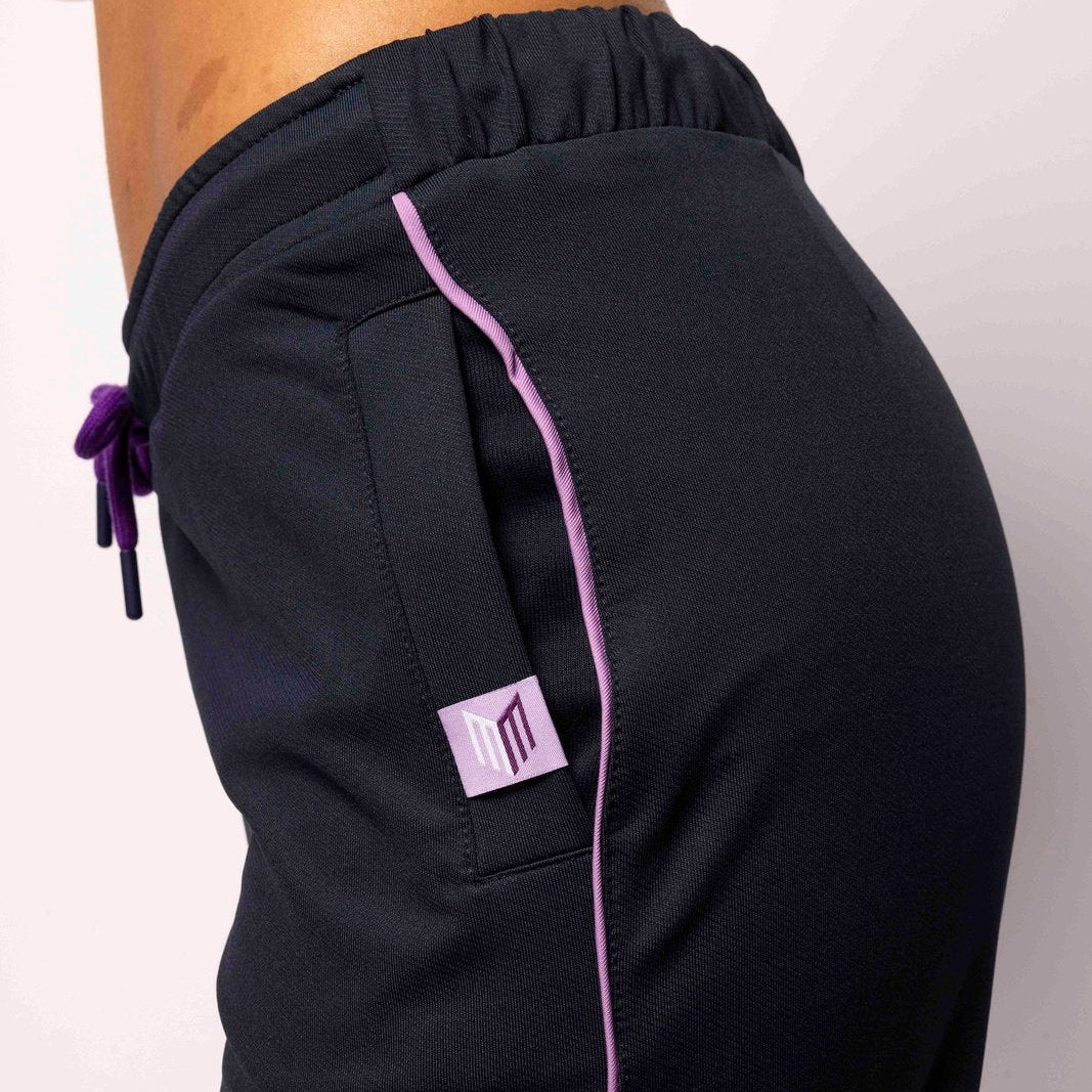 Black pants with pink accents on a plain background