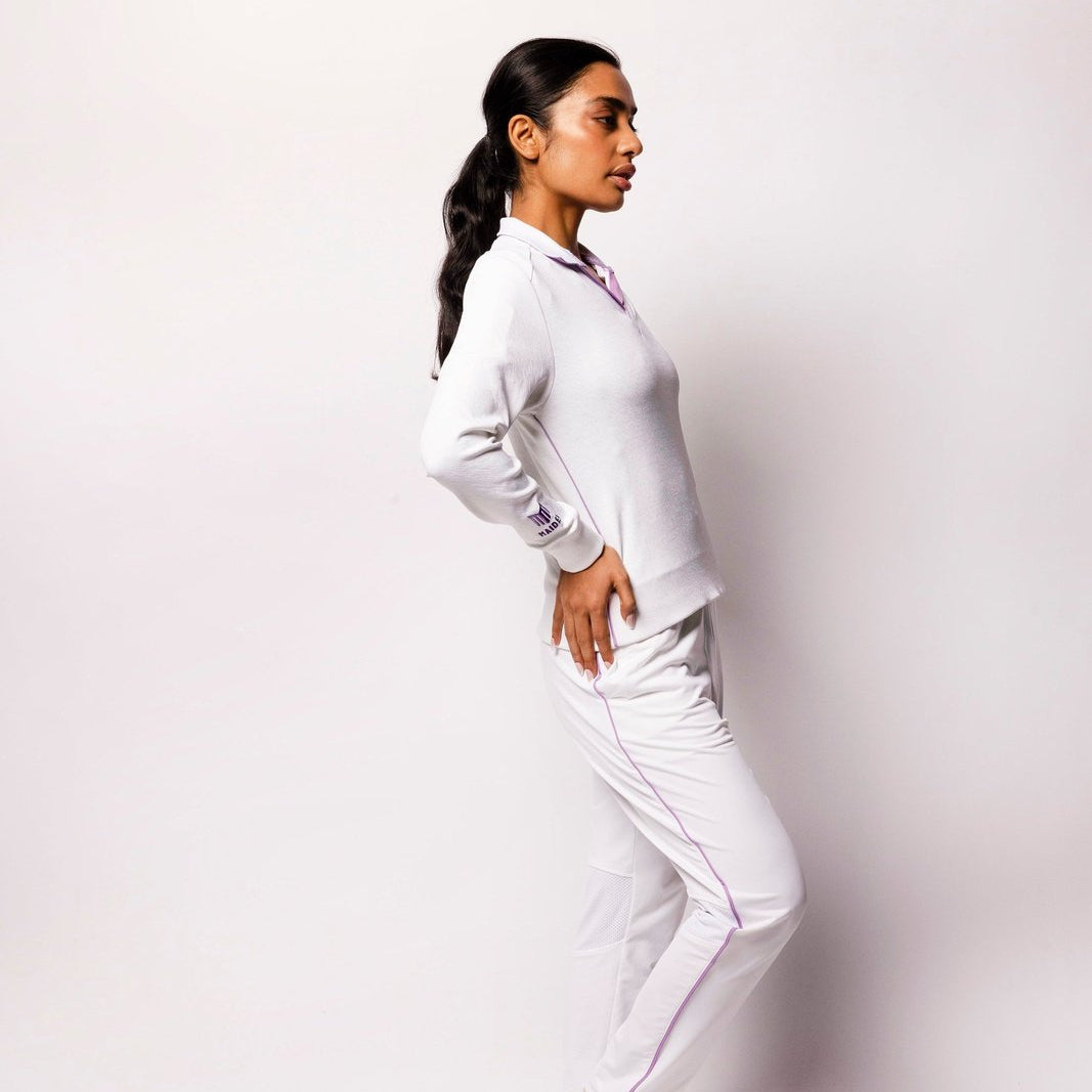 Woman wearing a white outfit against a plain background