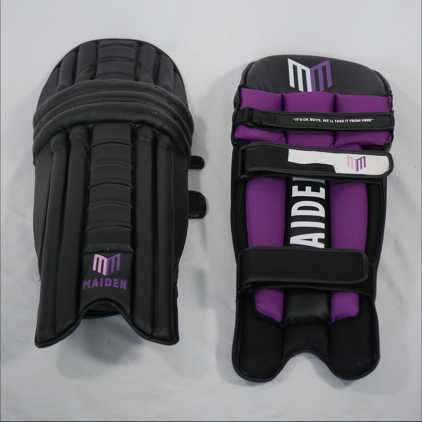 Pair of black and purple shin guards with 'MAIDEN' branding on a gray background