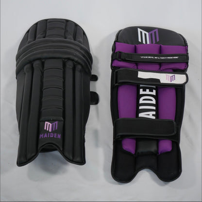 Pair of black and purple shin guards with 'MAIDEN' branding on a gray background