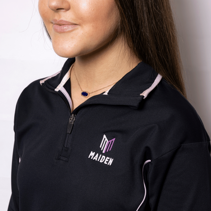 Person wearing a black jacket with 'MAIDEN' logo on a plain background
